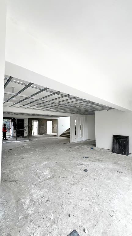 Interior with white walls and ceiling grid installation